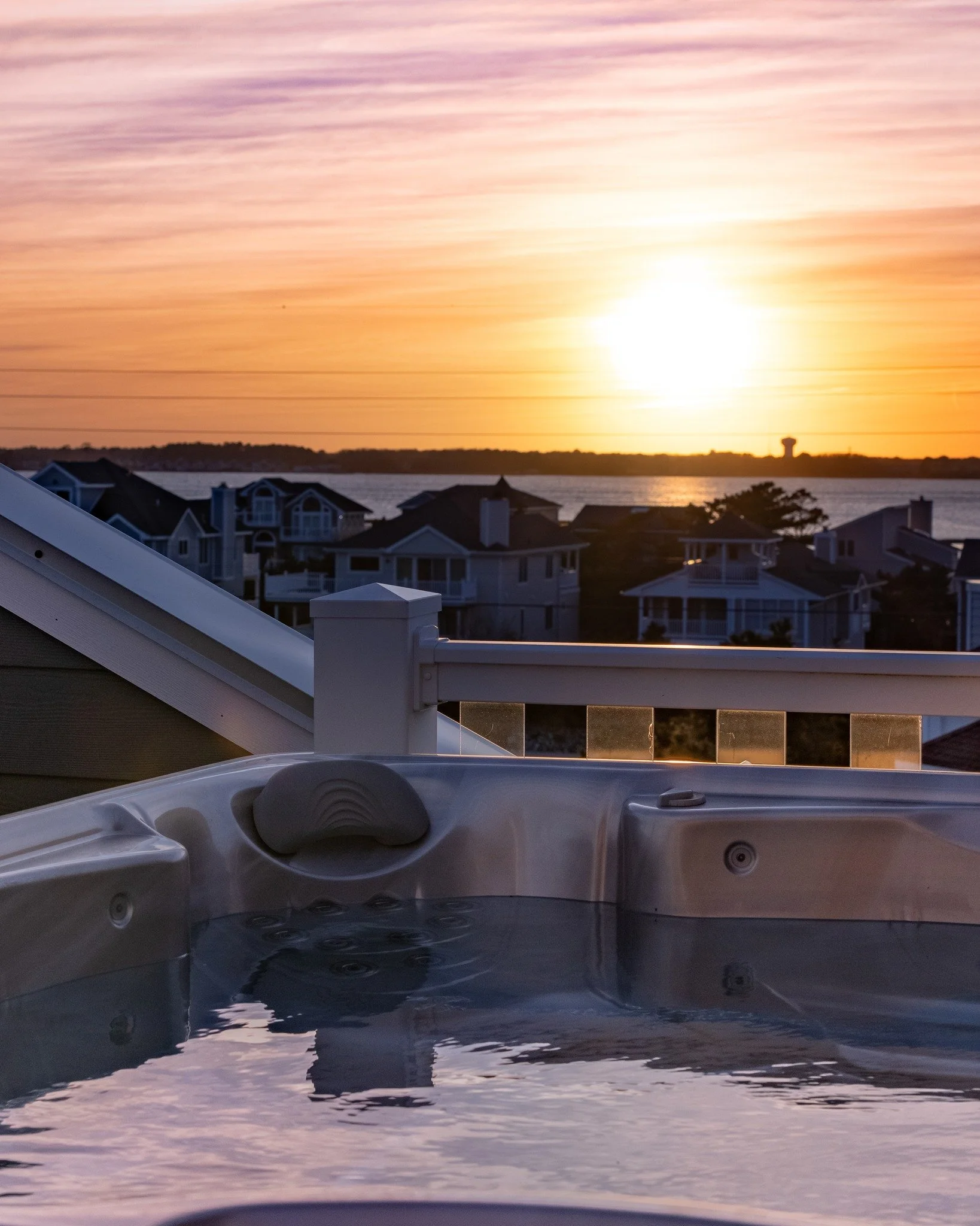 Over the next two weeks, we&rsquo;ll be unveiling more of this remarkable coastal home.
From the warmth of the hot tub, the view stretches across the porch and out toward the final glow of sunset &mdash; the sky softening, the light reflecting across
