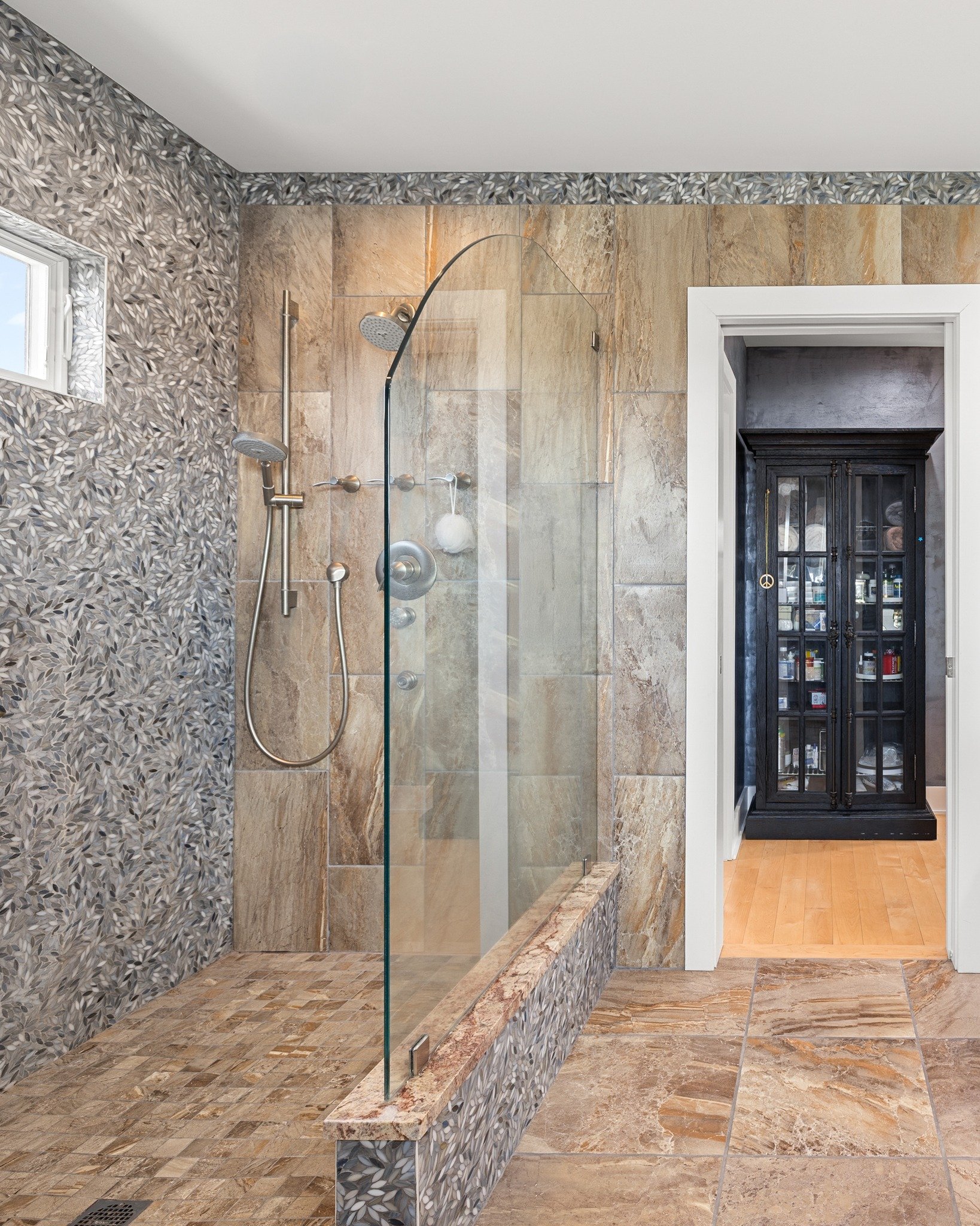 Some spaces are designed to help you slow down.
In this bathroom, a glass-walled shower opens the room and lets the beautiful tilework take center stage. Soft textures, clean lines, and thoughtful finishes create a space that feels calm, refined, and