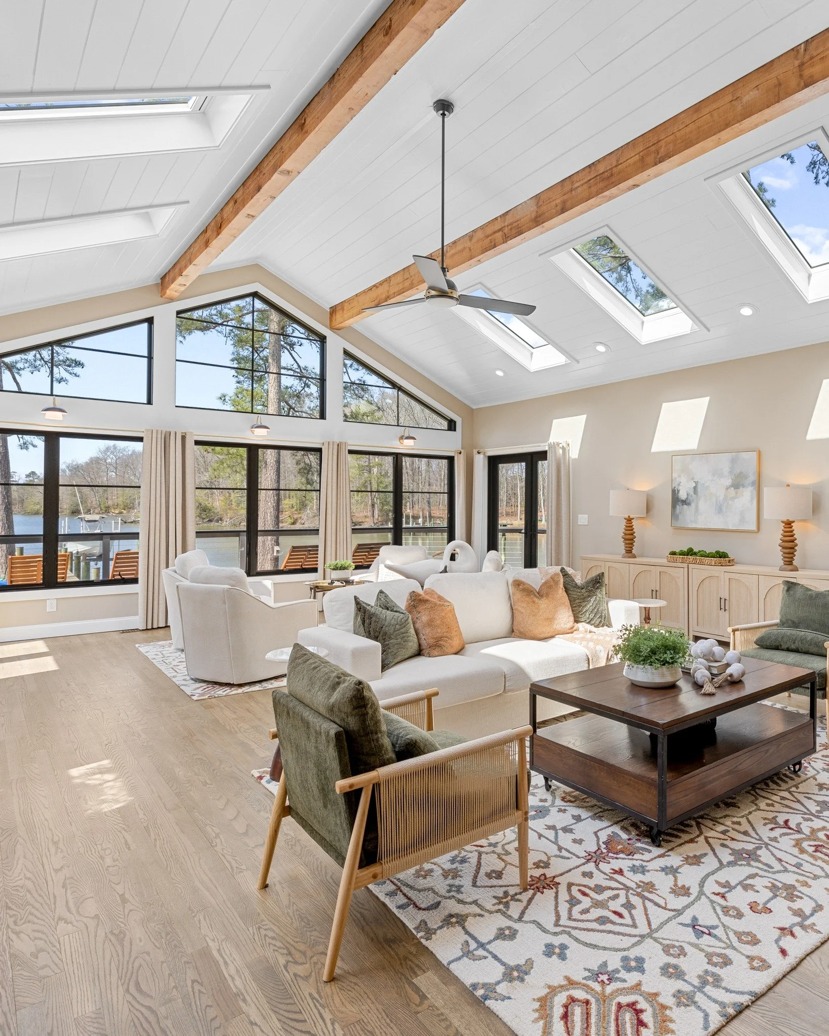 From multiple angles, the living room reveals its balance of modern style and everyday warmth. Rich green seating paired with honey-toned wood adds depth, while the washed brick fireplace brings in a soft, timeless texture.
And then there&rsquo;s the