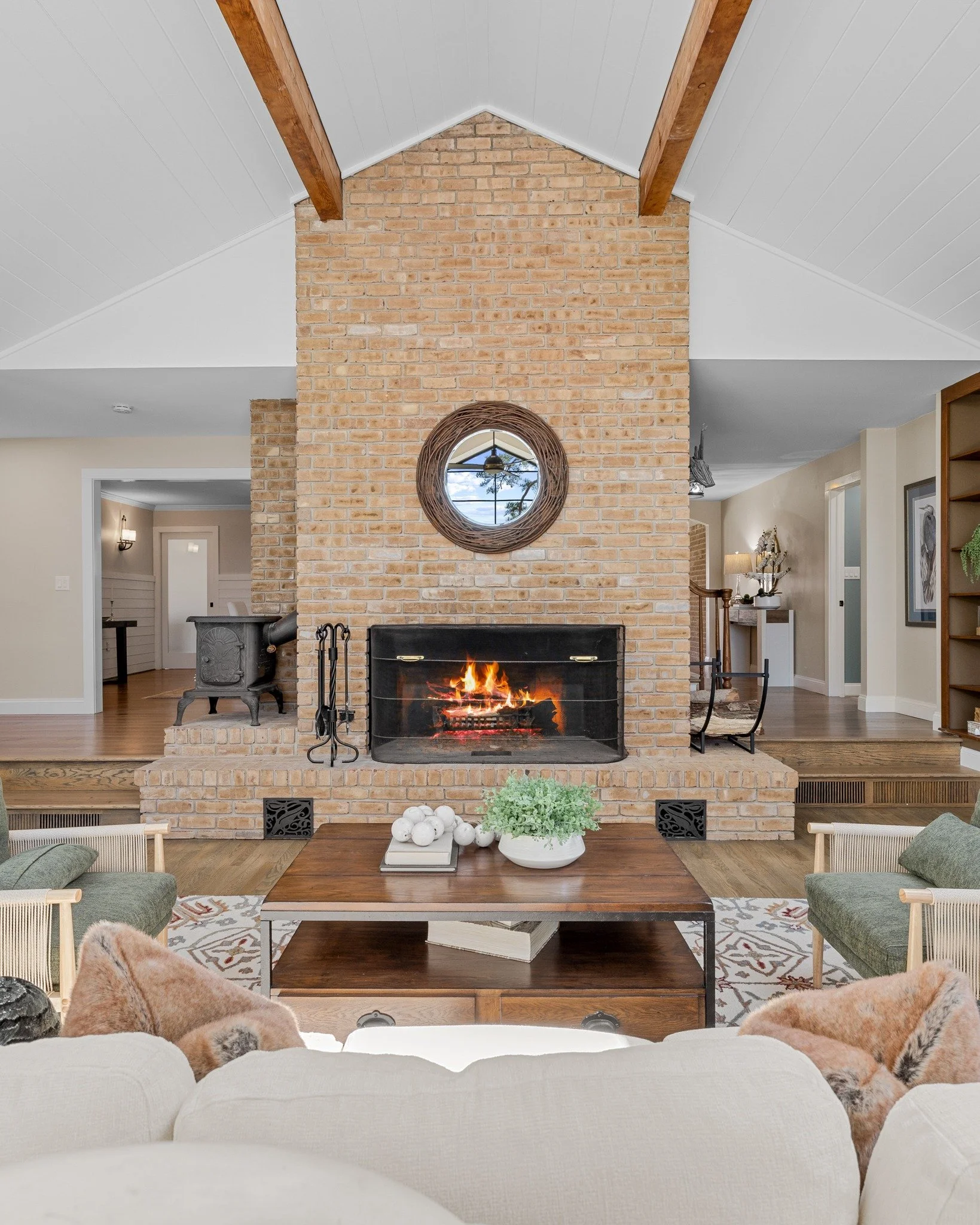 From a distance, the fireplace anchors the room &mdash; drawing your eye in while complementing the architecture above. The lines of the ceiling, the openness of the space, all working together with it at the center.
Up close, the texture tells its o