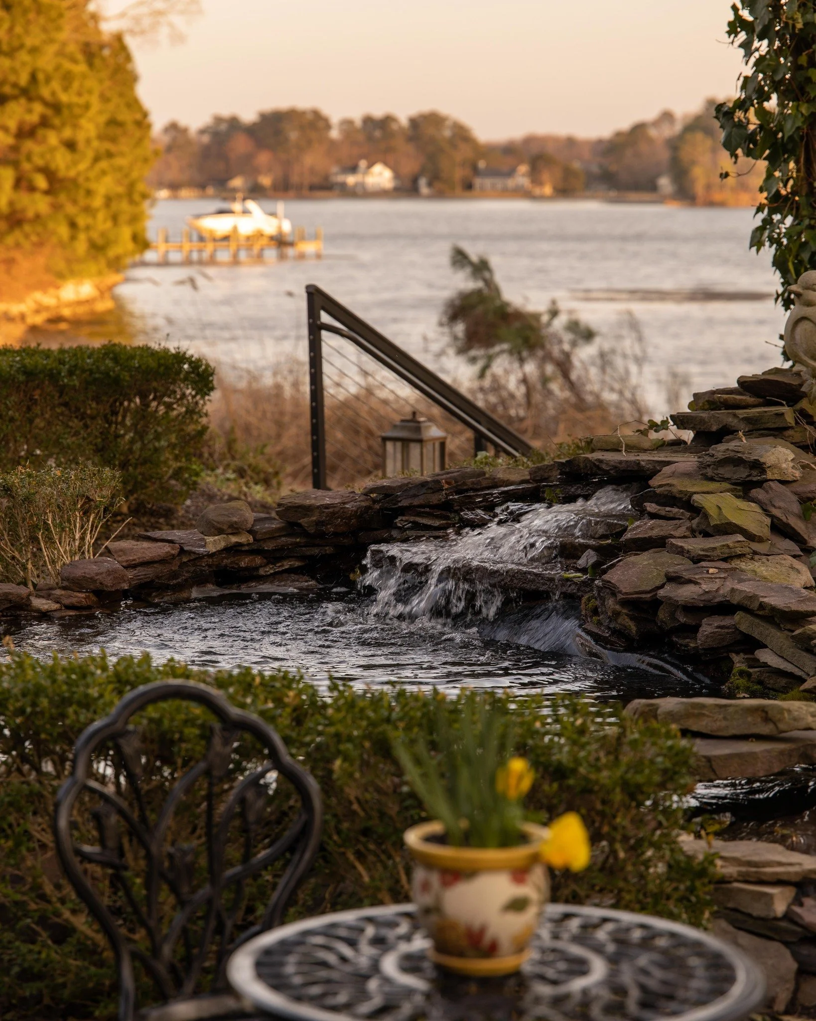 Designed with intention. Experienced in layers.
From the movement of the fountain to the stillness of the water beyond, every element was curated to elevate the outdoors into something exceptional.
The covered porch &mdash; anchored by a statement fi