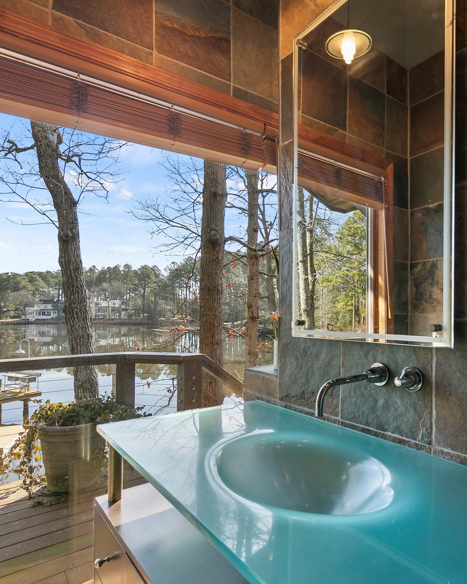 Where everyday routines feel elevated.
Dual vanities designed with intention &mdash; paired with a wall of windows that brings the outside in.
Morning light, water views, and a space that feels as calm as it is refined.
This is more than a master bat