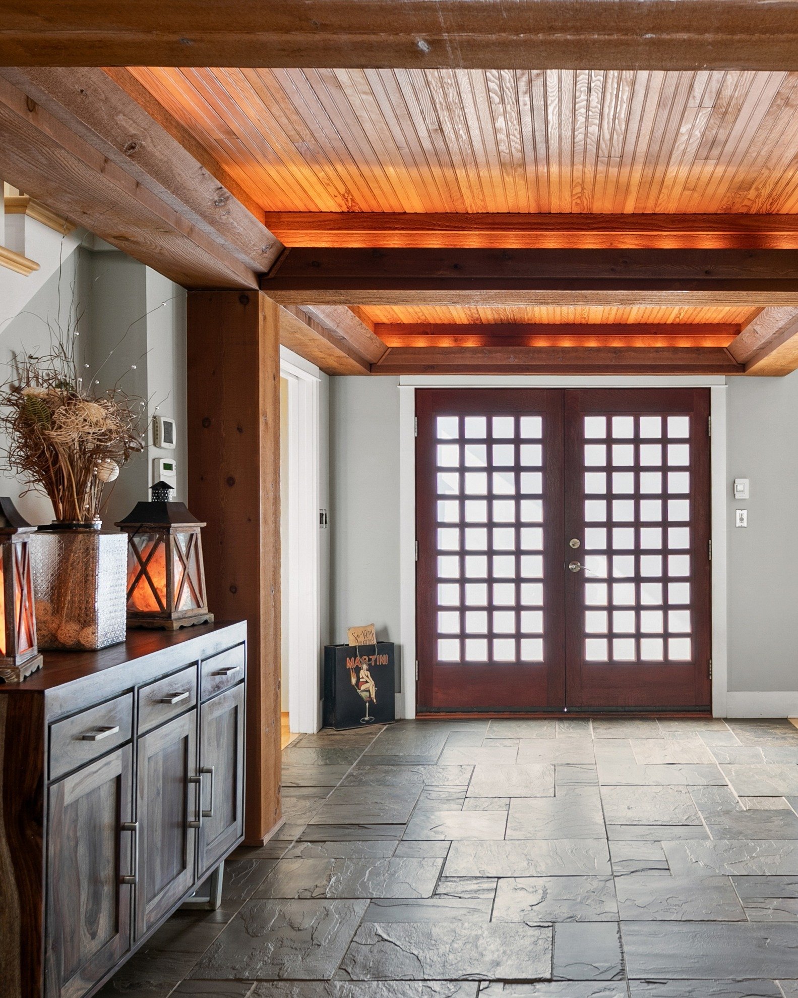 The welcome and the goodbye&hellip; from both sides.
As the door opens, natural light leads the way &mdash; highlighting rich wood tones and the craftsmanship that sets the tone from the very first step.
From within, the entry becomes a statement of 