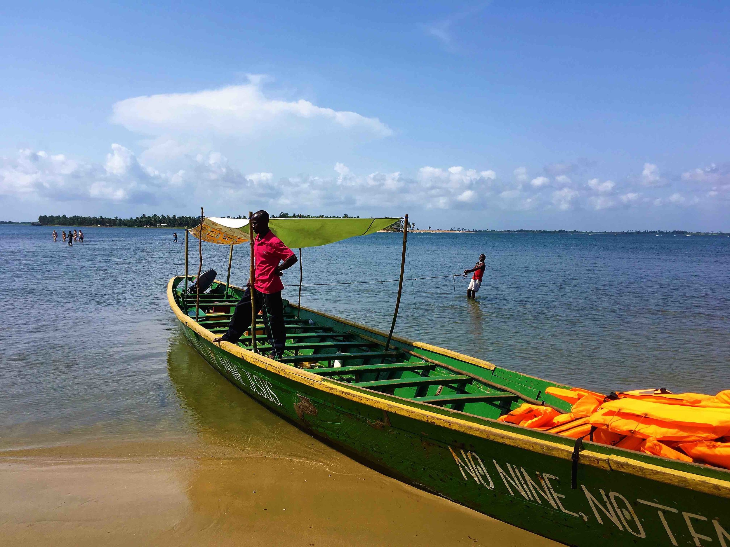 lrThe boat that we took to our island. The boy in the water holding the rope was most likley a child slave.jpg