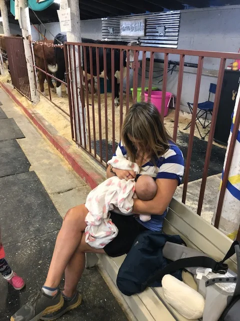 We went to the county fair. So, naturally, we had to take a nursing pit stop in the dairy barn.
