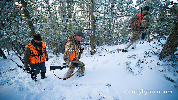 Hunters hunting though the snow covered forest of montana. Montana Photographs. (Tony Bynum/tonybynum.com)