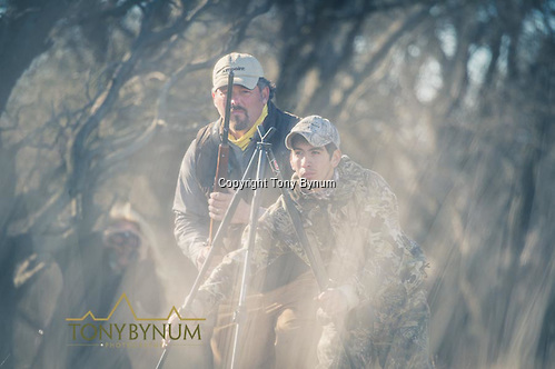 Hunter getting ready to place his rifle on the shooting sticks. La Pampa, Argentina ©tonybynum.com