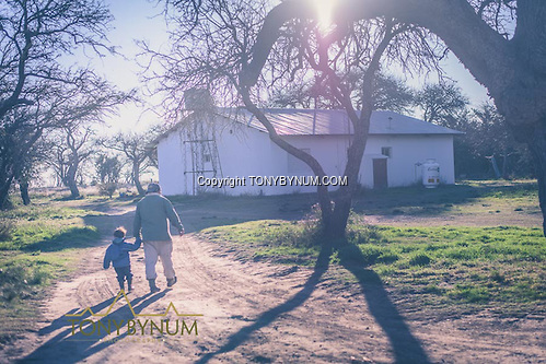 The skinner walking his son home after processing game. La Pampa, Argentina ©tonybynum.com