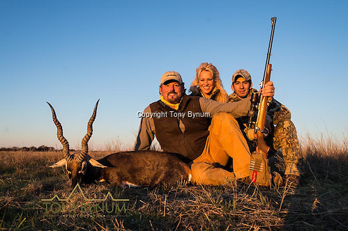 A man, his wife, and guide with a mature blackbuck. La Pampa, Argentina ©tonybynum.com