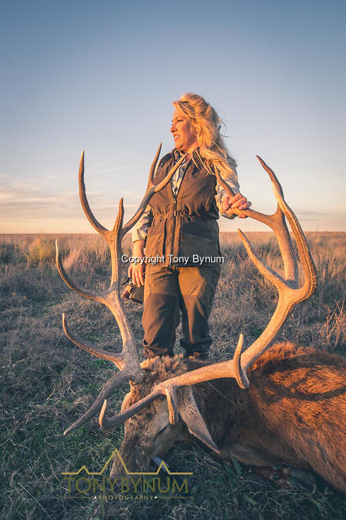 A woman with her large, free range, trophy stage taken on the Los Molles Ranch. La Pampa, Argentina ©tonybynum.com