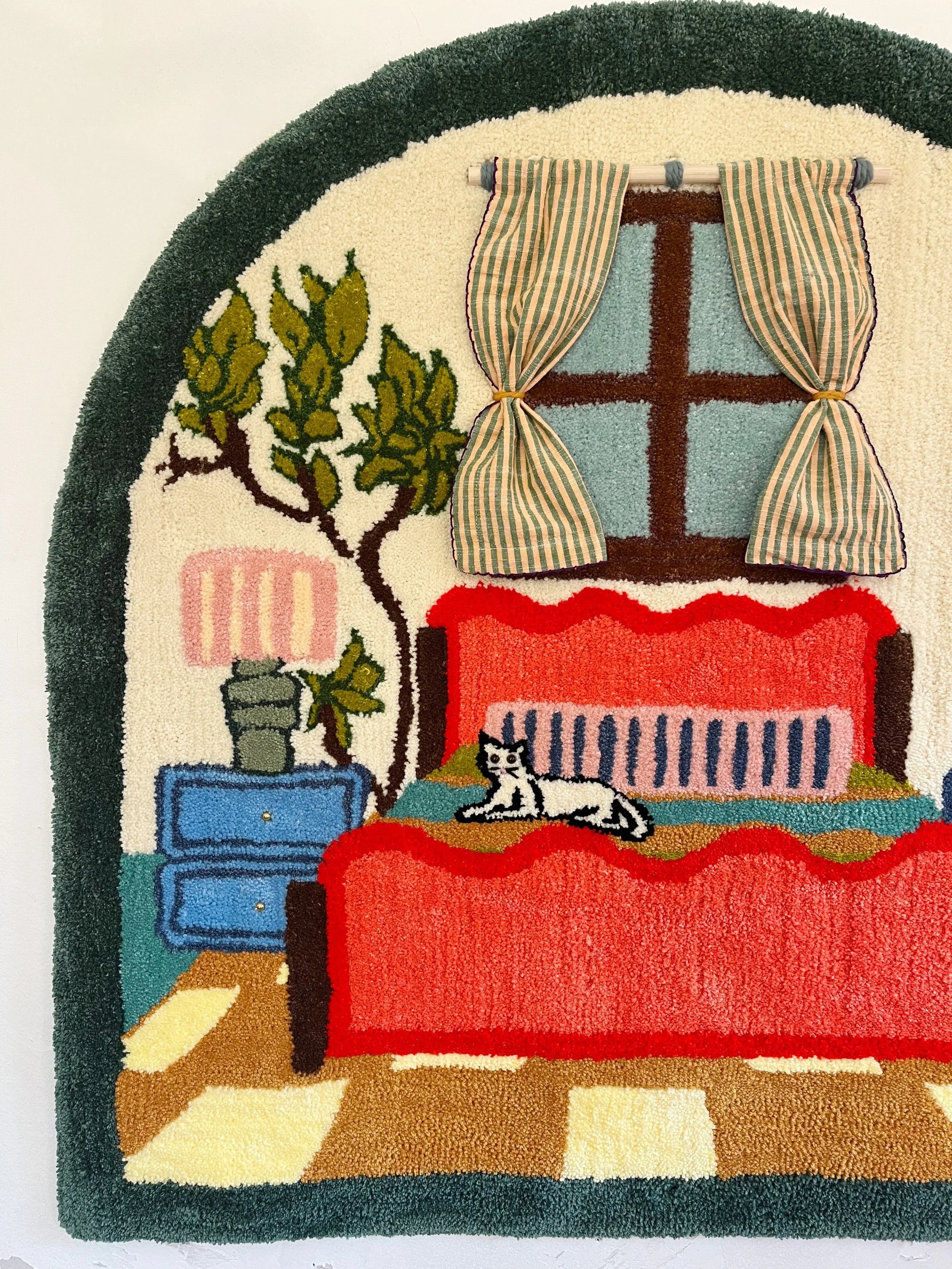 Close-up of Tufted Home #4 showing the handmade fabric curtain accents, metallic gold details, and plush wool textures of this interactive fiber art piece.