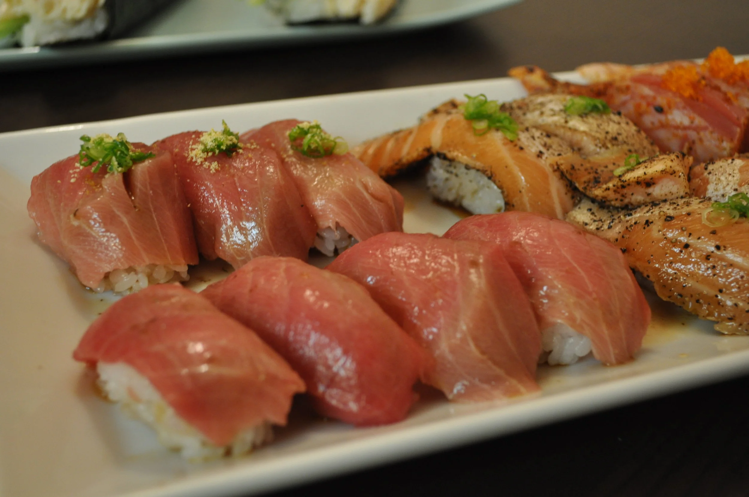  Chu-toro Maguro Nigiri two ways:   ponzu with yuzu and green onion (top left)   regular cut with soy 