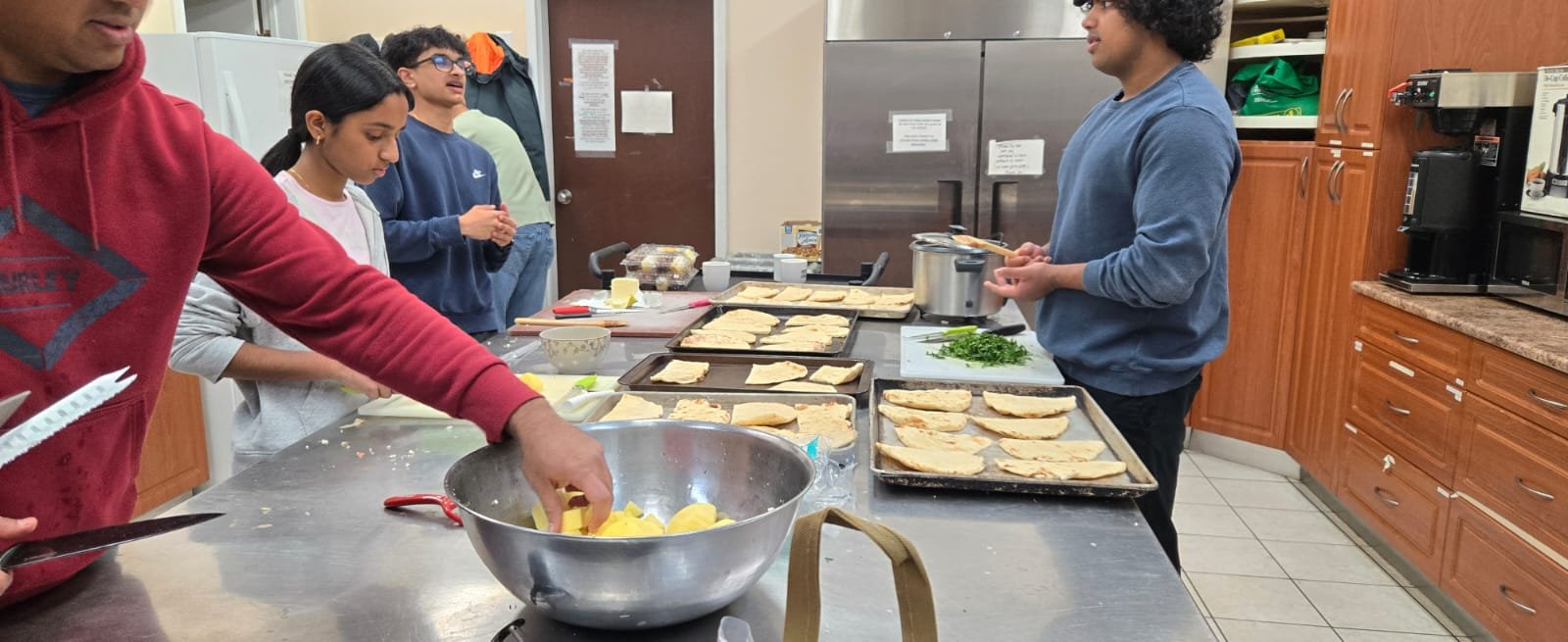 In October 2025, YLSBC youths and parent mentors were in the kitchen to help prepare the hot meals.