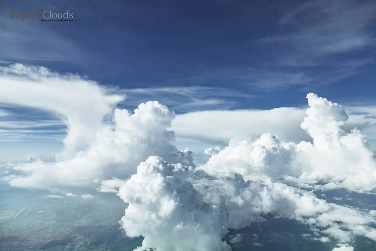 Some impressive cumulonimbus clouds to our right. You can see that the right clouds is still in its building stage, thus not yet fully grown while the one to the left is already in its dissipating stage indicated by the less clear shaped contours and the anvil top.