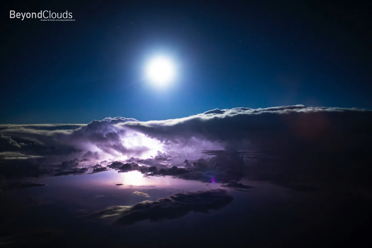 An impressive thunderstorm with lightening over the vast desert between Los Angeles and Las Vegas on a full moon night. What a sight.