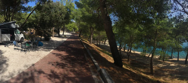 Park up amongst the trees, just by the sea.
