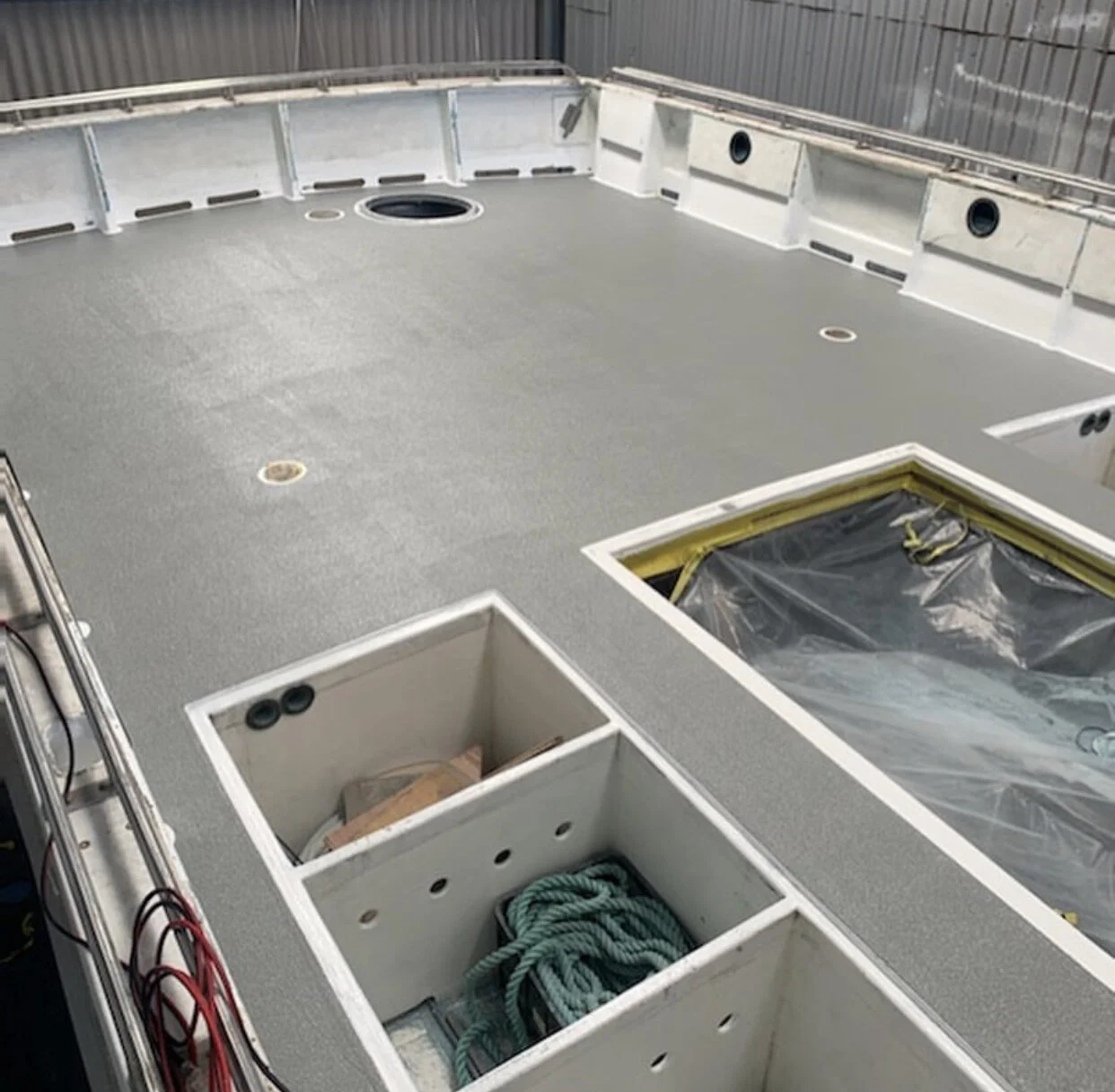 Fibreglass and gelcoat repair work in progress on a hull at the Fremantle yard