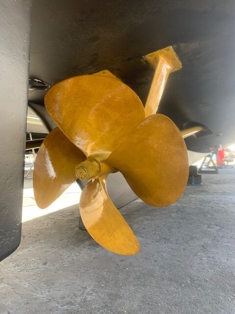 Antifouling paint being applied below the waterline on a hauled-out hull