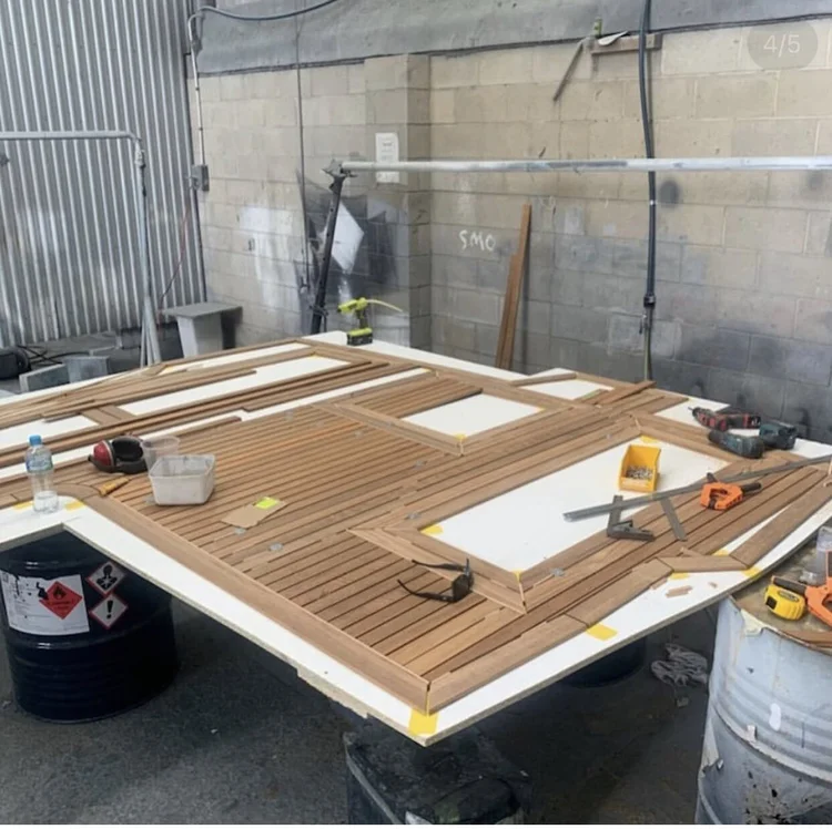 A new teak deck being laid