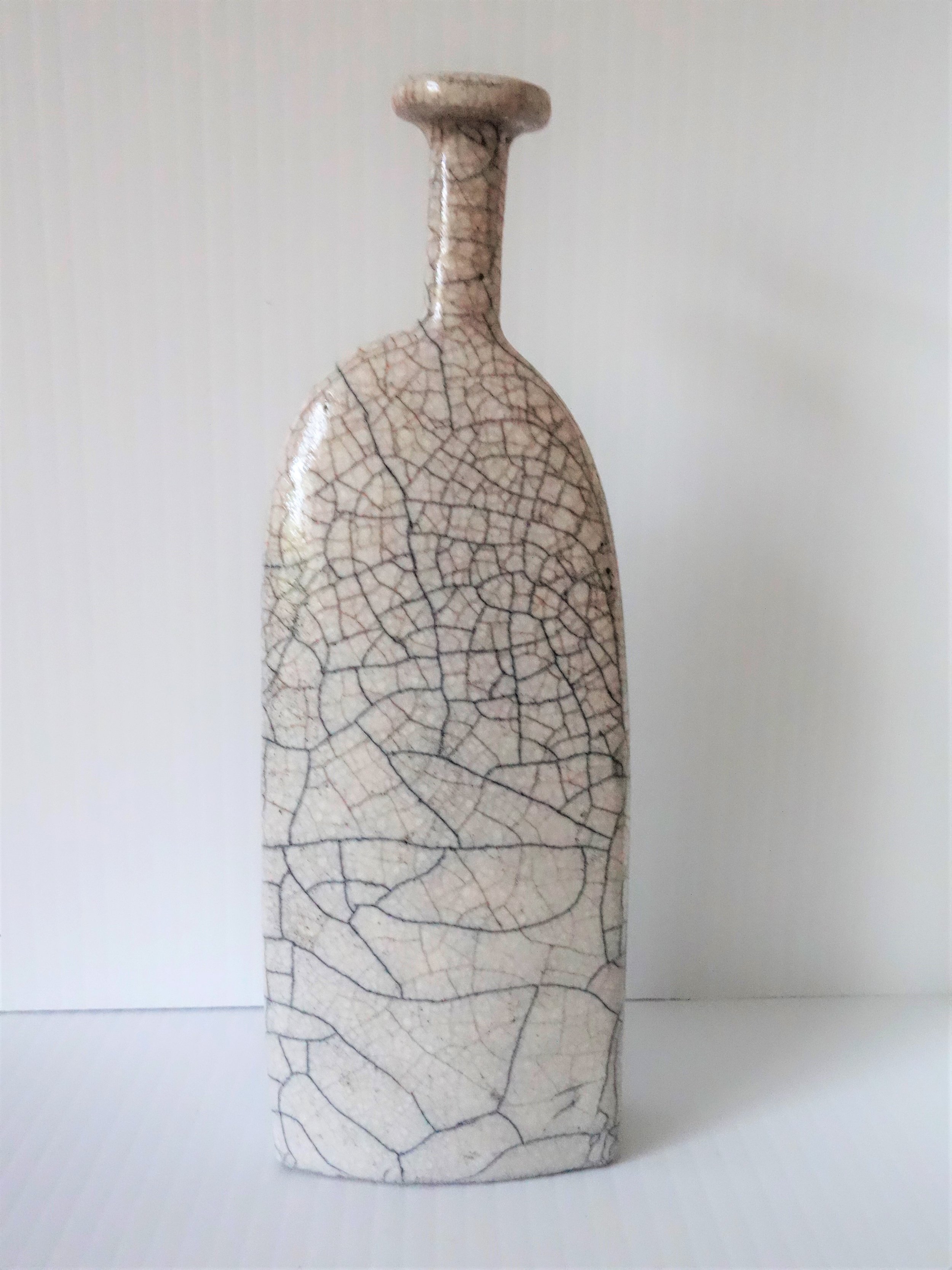  Title: White Raku Bottle (round top) Size: 18 cm (h) x 6 cm (w) Medium: Raku Price: £110 