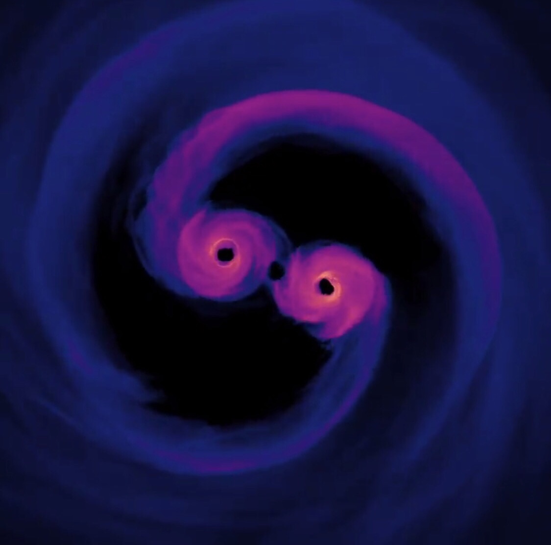 IMAGE: NASA. Computer simulation of two supermassive black holes colliding