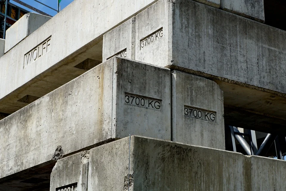 Concrete slabs making up the foundation of a large building. The slabs are stacked on top of each other with a few gaps and empty spaces.. This relates to Belinda’s Alexander Technique Basics class as you can see, when you build a foundation, there are often gaps left to be filled in at a later date.
