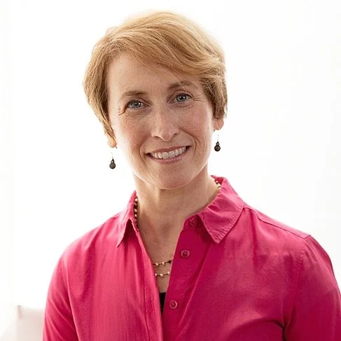 Headshot of Belinda Mello, Alexander Technique Teacher and Acting Coach. Belinda wears a magenta pink button down and smiles to the camera.