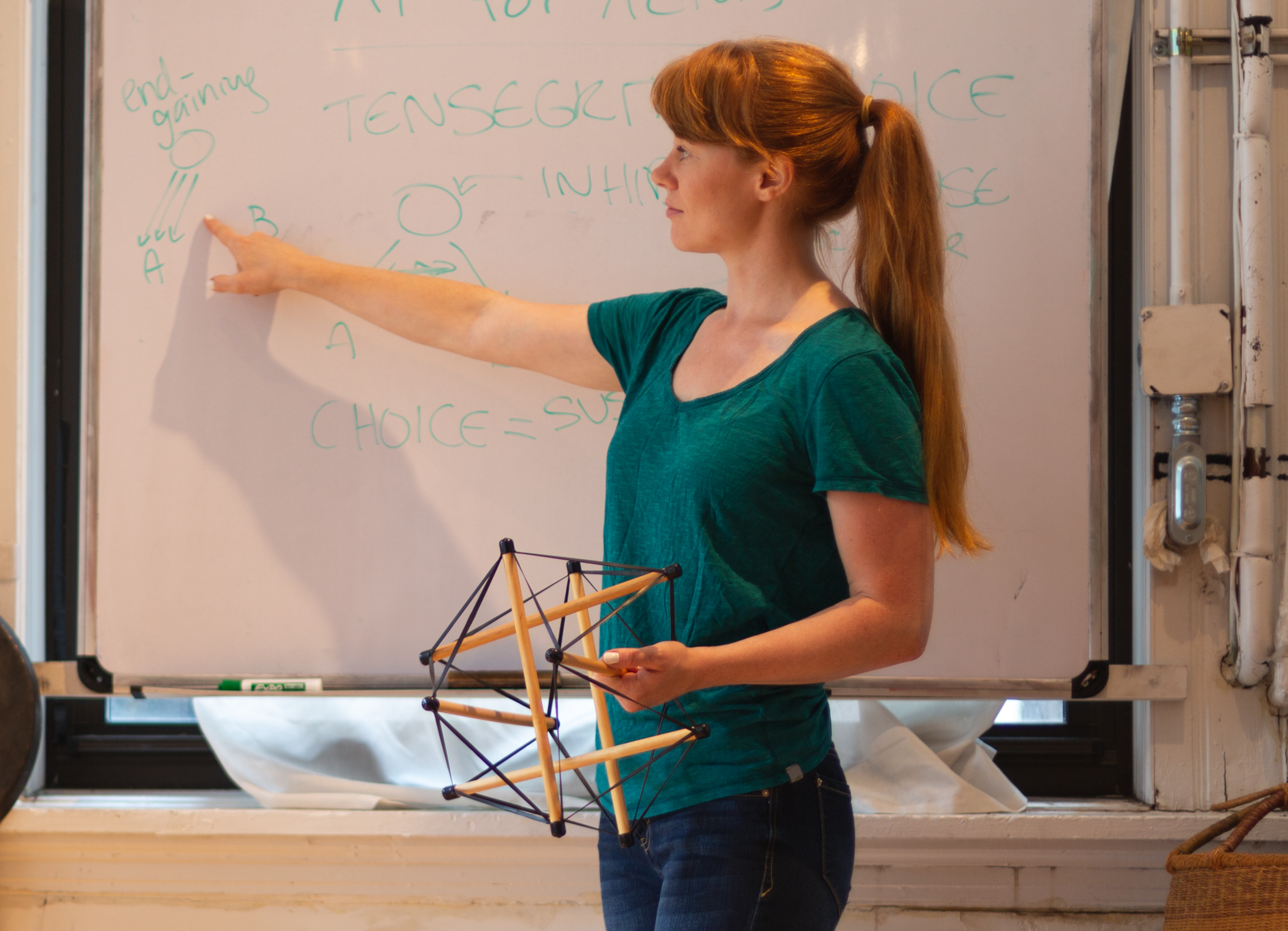 Holly Cinnamon, Guest Alexander Technique Teacher at AT Motion Center for Actors, teaching a student with her hands on the students ribs helping the student how her ribs move while breathing.