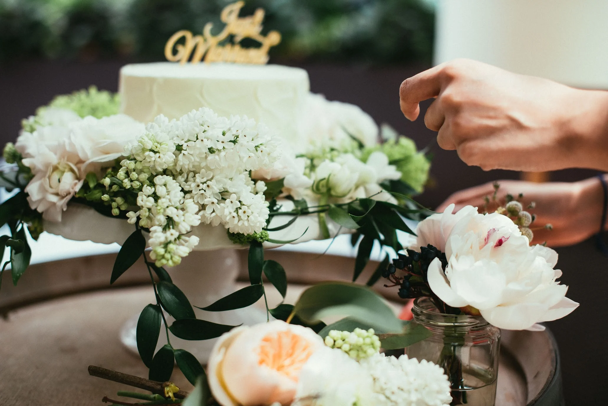 Flowers surrounding cake : Hanoi Ranunculus | Syringa | Peonies | Italian Ruscus