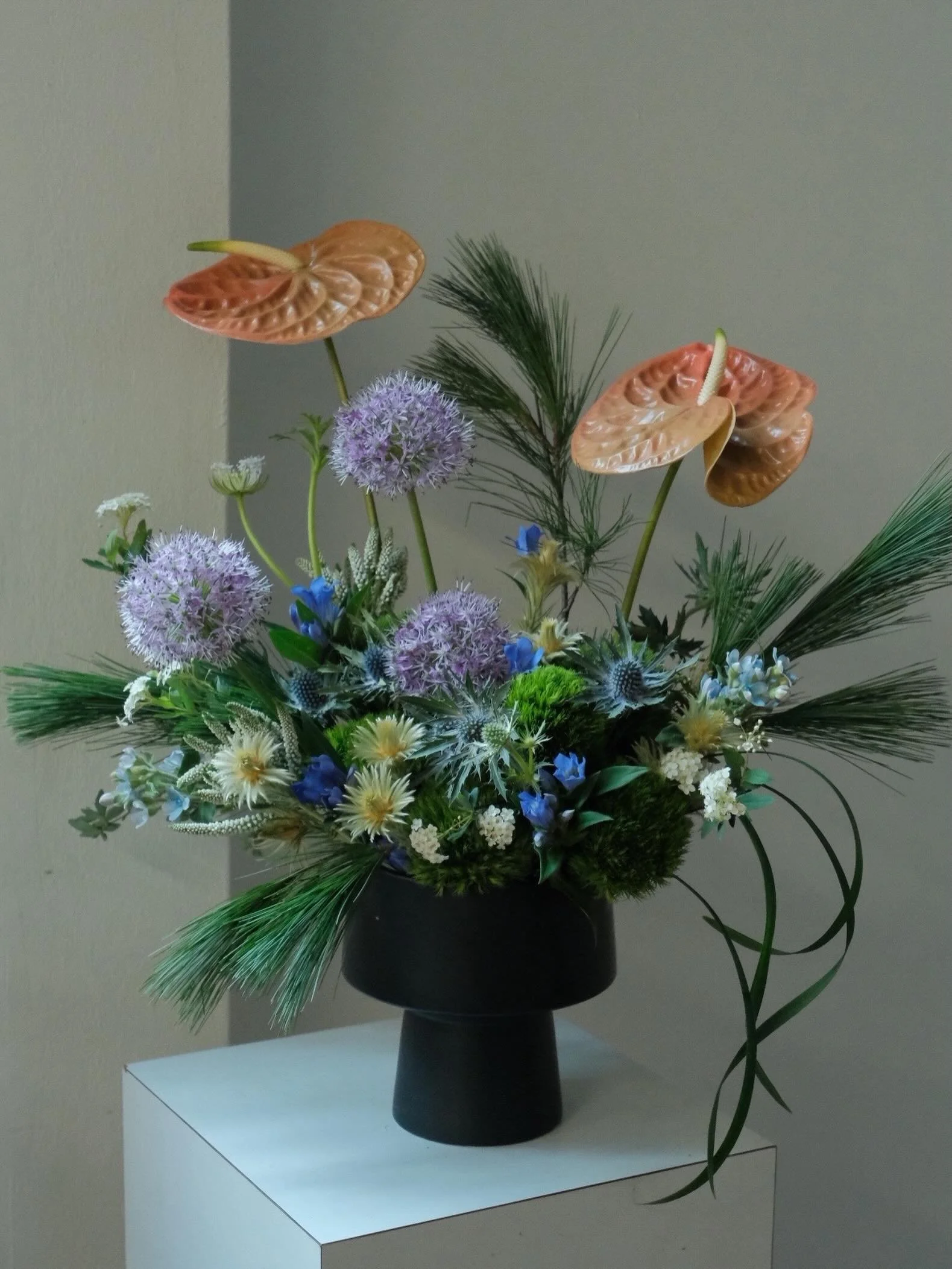 A touch of structure, a touch of nature, a touch of us.

A miniature floral scape, if you will&mdash;bonsai-esque, but a little unexpected.