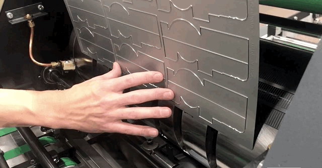 Above is a flexible die tool being mounted on a single magnetic Insignia6 machine utilizing a recessed scribe line to ensure die is parallel on the cylinder, and then aligned to a center scribe.