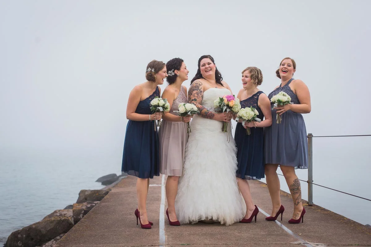 Bridal Party Fun Pier downtown Two Harbors north shore wedding foggy weather fog lake superior minnesota husband wife photography team minneapolis st paul twin cities wedding photographer