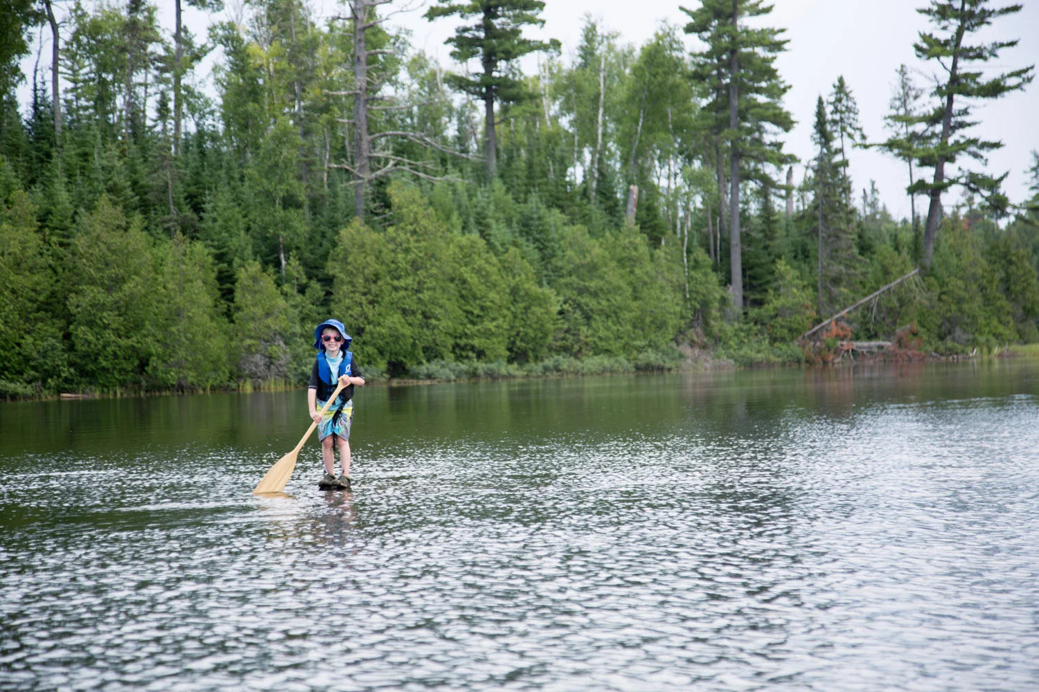 We found a rock just barely under the surface of the water, Hani wanted to make it look like he was standing on the water and paddling!