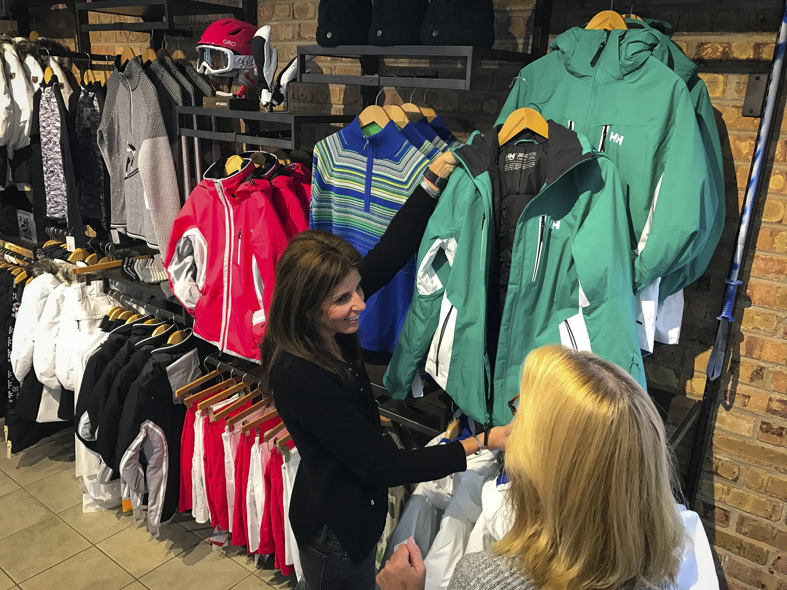Customer being helped in clothing department by Williams Ski and Patio team member.