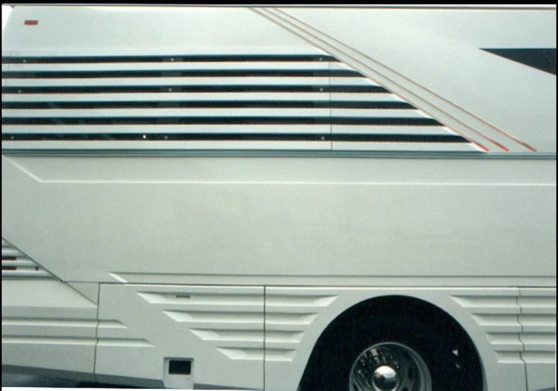 Side detail. Reducing drag where ever possible was paramount in the body design. All exterior marker lights were flush with the body. Fiber Optics located in the middle wing elements can be seen illuminated in Red. The upper rear, wrap around slats hid privacy windows. From the inside the slats over the windows didn’t hinder views from the state room.