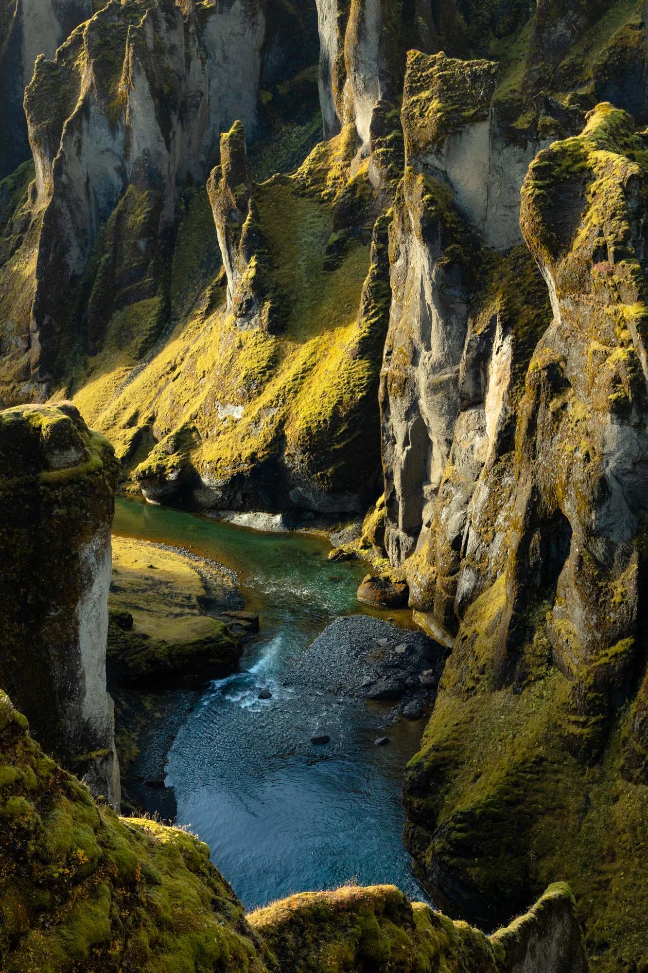 Soft northern sunlight highlights the ridges and curves along the mossy walls of the Fjaðrárgljúfur canyon in the south of Iceland. The canyon was formed at the end of the last ice age when a powerful meltwater river dug 100 meters through the layers of sediment and rock. Though only a small stream flows through the canyon today, landscape features like these hint to the staggering power of melting glaciers. 