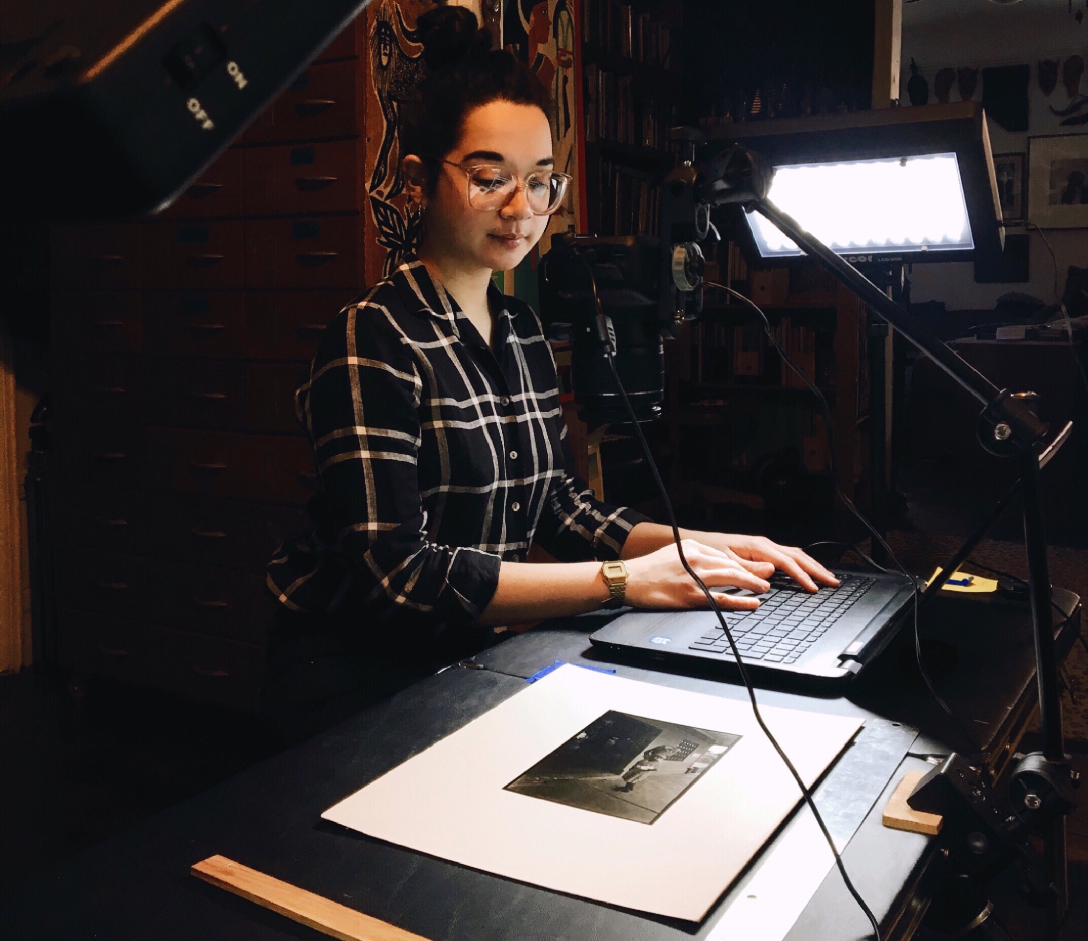 PCPP Administrative Fellow, Nicole Kaack, cataloguing Shawn Walker’s photographic collection. Photography by Lizette Terry.