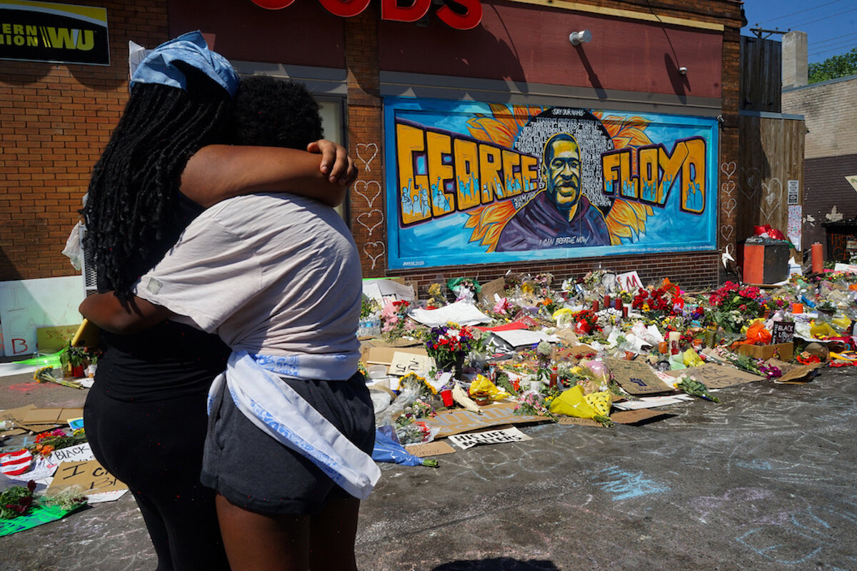  “June 1, 2020 - Minneapolis, Minnesota - Two friends grieve together in front of a mural and vigil for Mr. George Floyd at the location where he was killed a white police officer. Mourners of all races, ethnicities, and various religious backgrounds