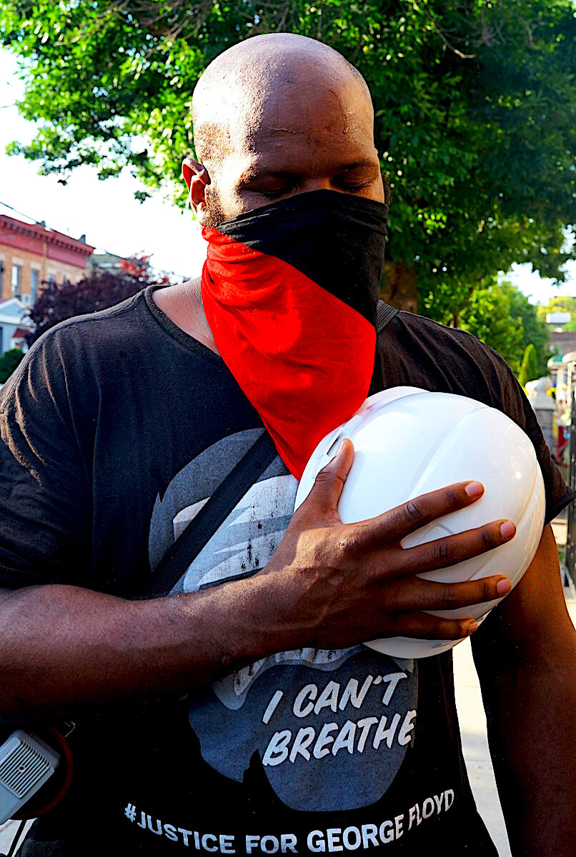  “June, 2020 - Brooklyn, NY - A protester marching for justice against police brutality takes a moment of silence to pay his respects for George Floyd.” © Russell Frederick 