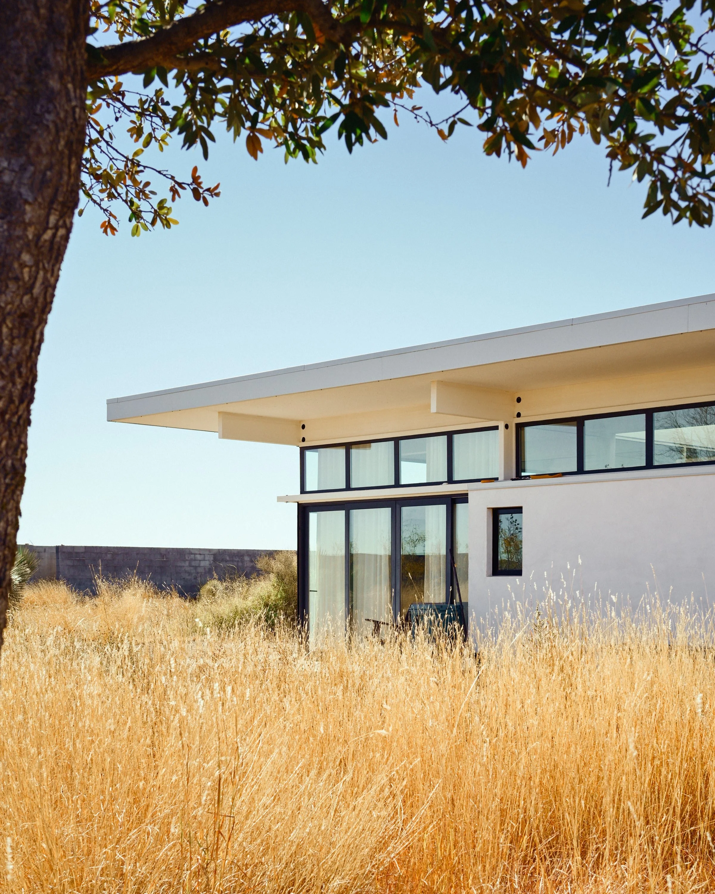 residential architectural photographer, modern desert home, Marfa Texas architecture, luxury residential architecture photography, flat roof modern home, floor to ceiling glass, custom home builder marketing, West Texas modern architecture