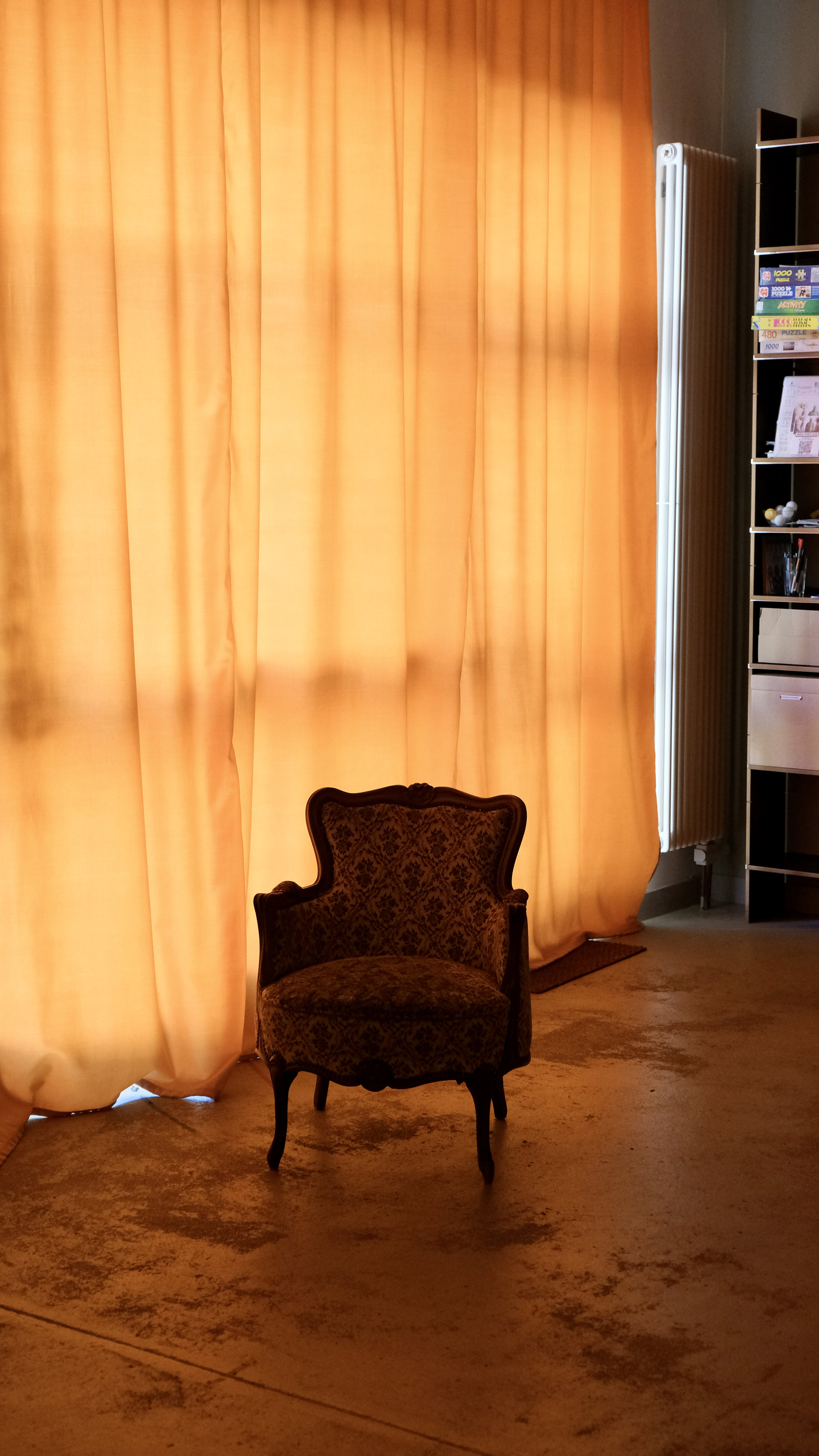 artsy picture of an armchair with closed curtains 