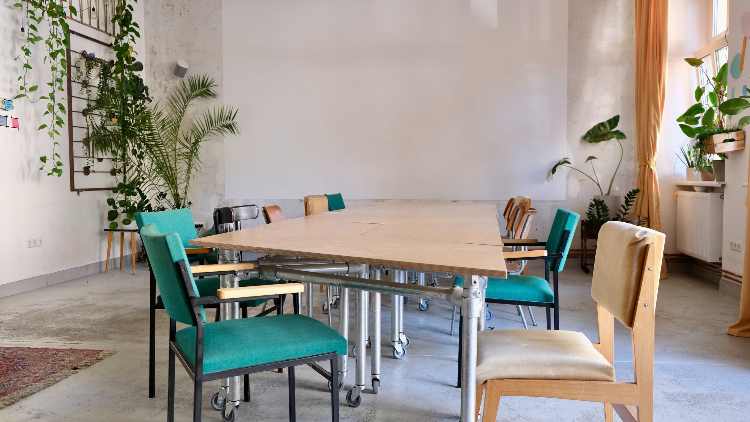 Main room in event space with long table formation 