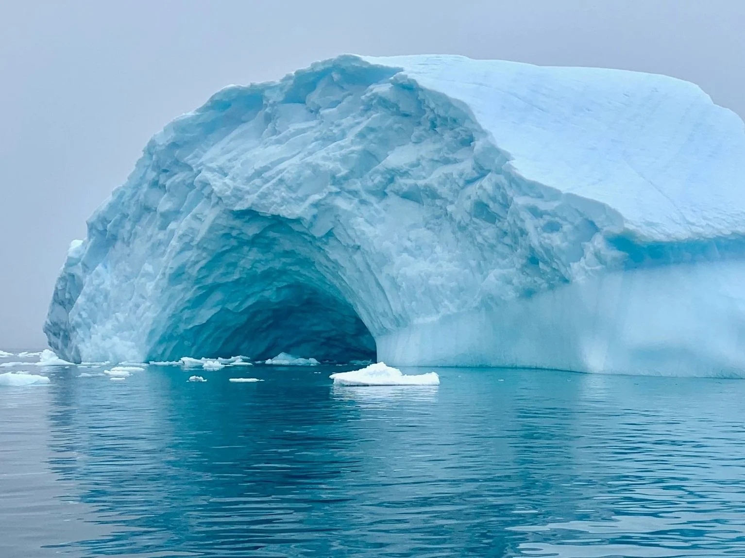 An iceberg in Antarctica with a cave-like opening