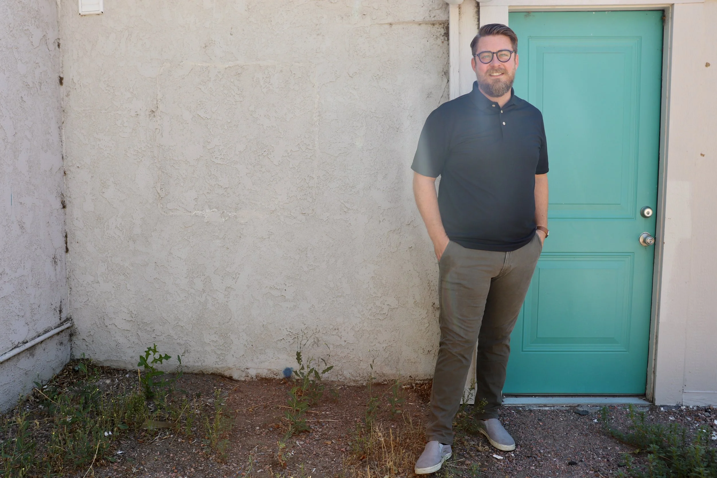 Scott Treas standing beside a teal door