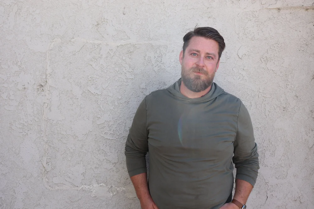 Portrait of Scott Treas in a green sweater