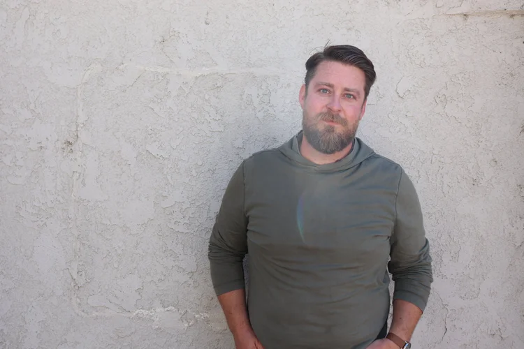 Portrait of Scott Treas in a green sweater