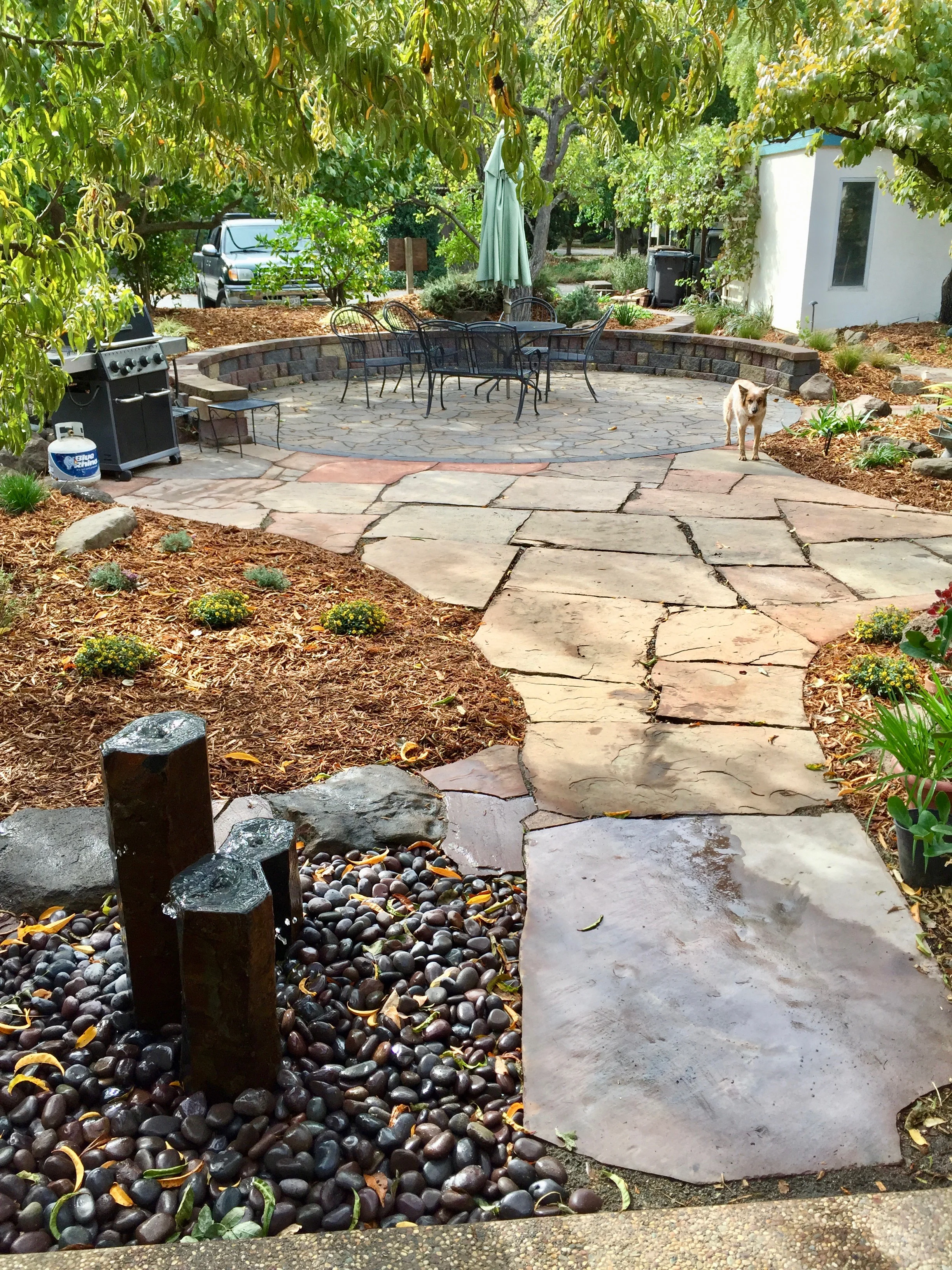  New fountain, flagstone, pavers, seat wall and plantings. 
