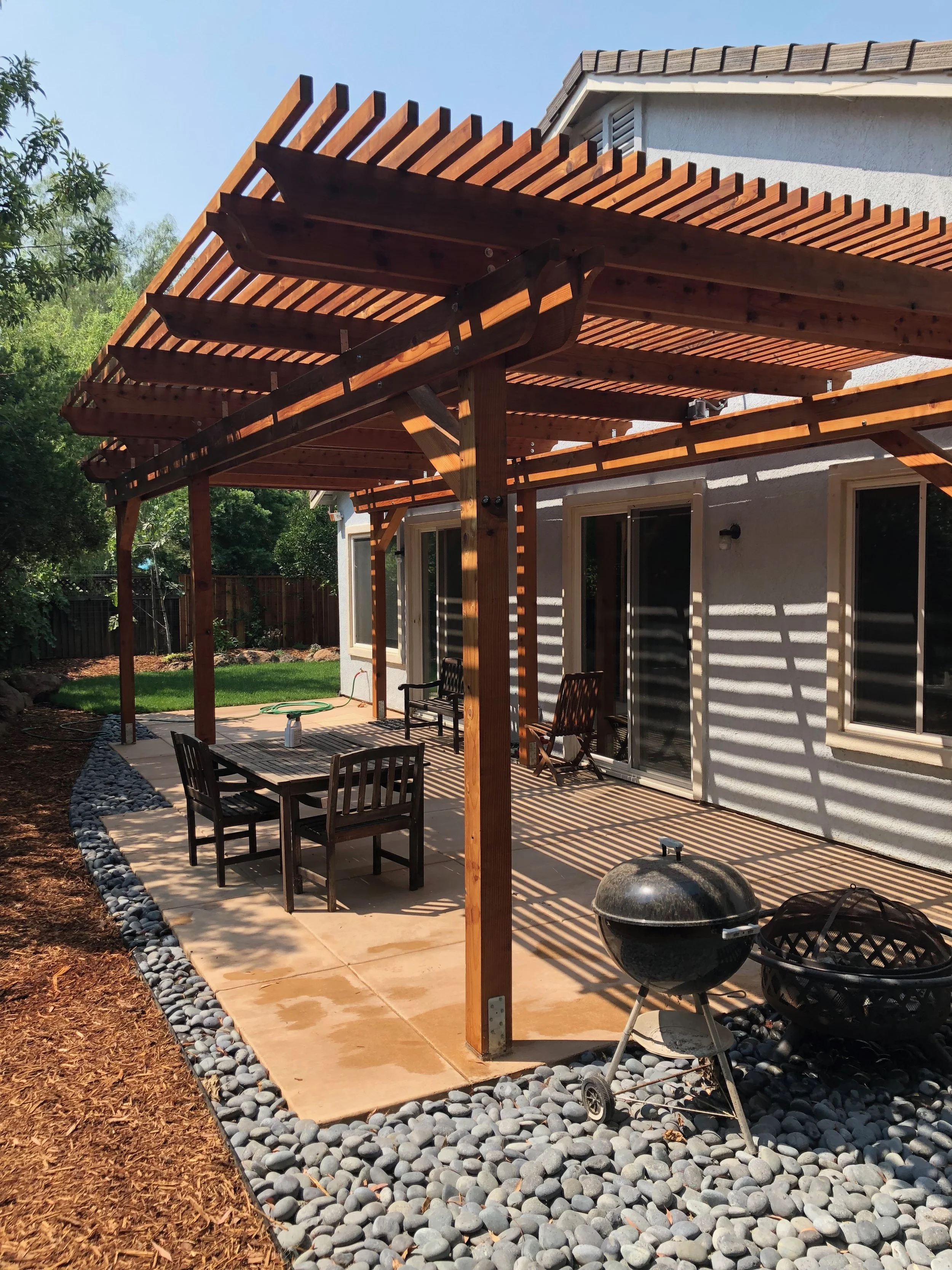  Custom concrete patio, redwood pergola and cobble.  