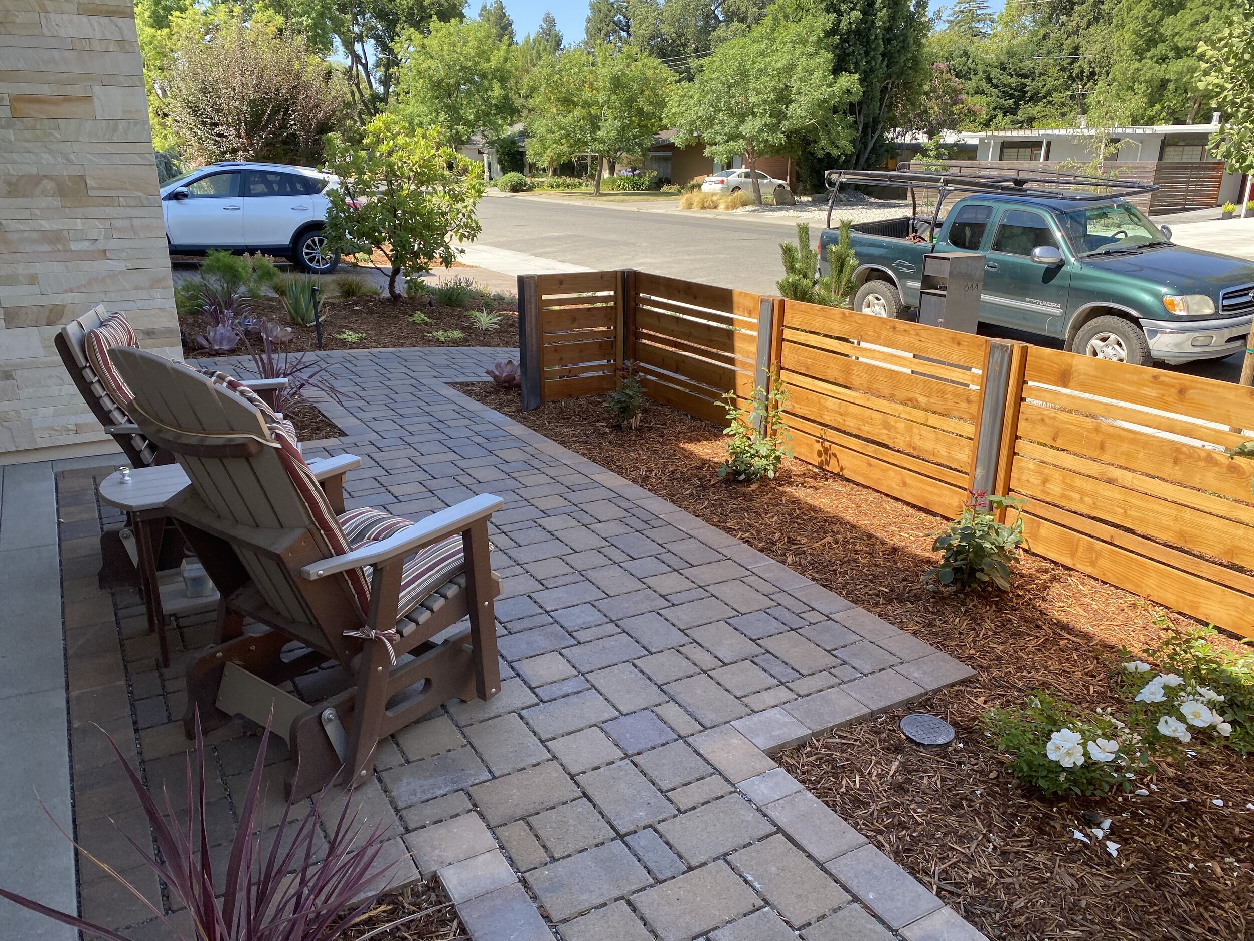  New courtyard with permeable pavers, plantings and custom steel and redwood fence.  