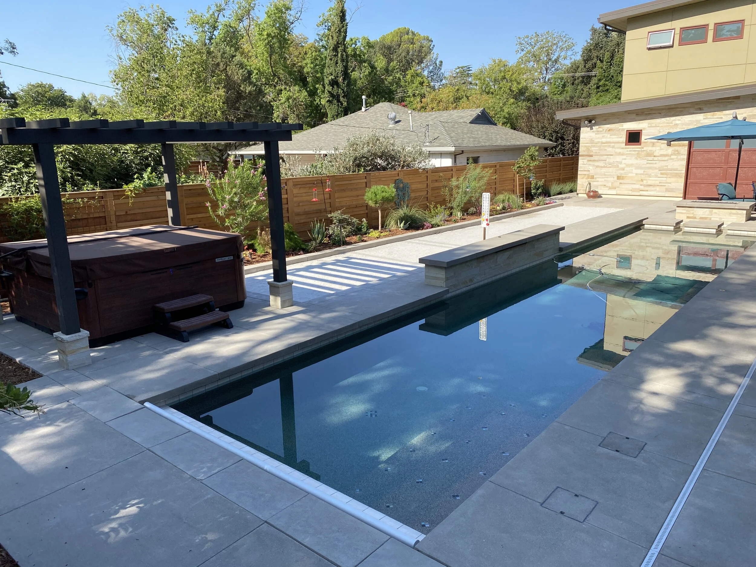  Full backyard design with new pool, hot tub, shade structure, bocce court, plantings, irrigation and mulch.  